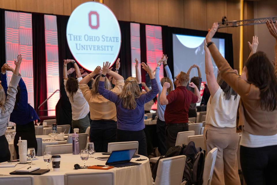Summit participants participating in a wellness workshop