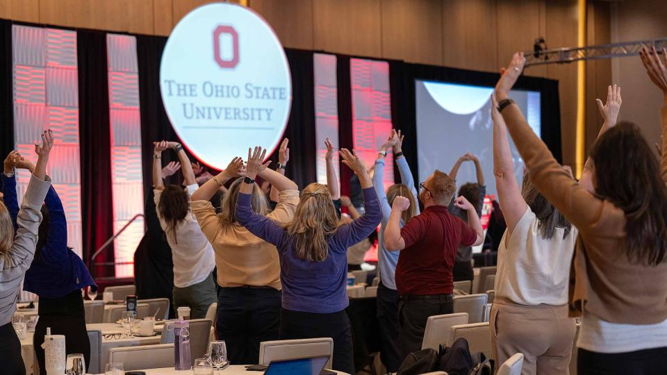 Summit participants performing breathing exercises